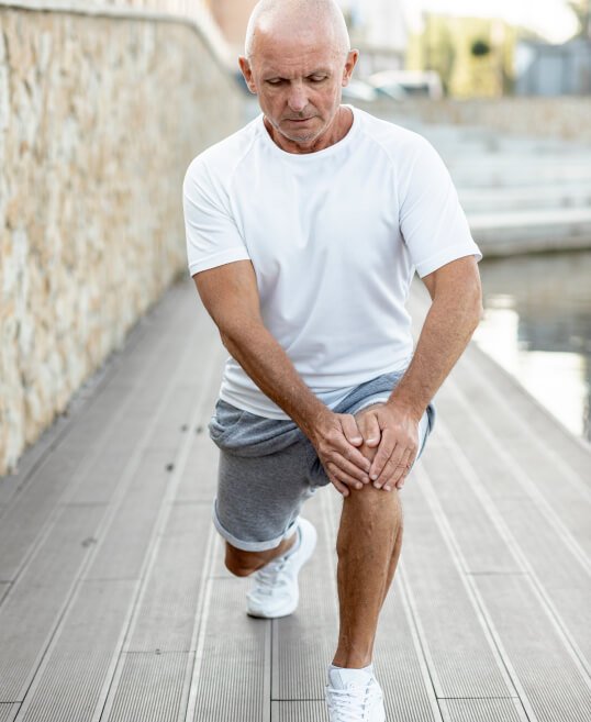 elder-man-stretching-alongside-water (1)